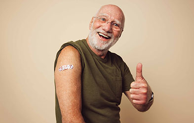 Vaccinated man giving a thumbs up